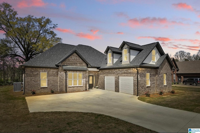 traditional home featuring a front yard, a shingled roof, concrete driveway, central air condition unit, and brick siding