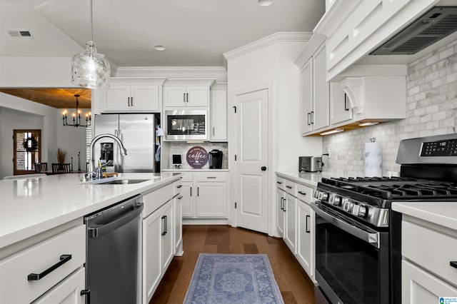 kitchen featuring pendant lighting, white cabinets, a chandelier, and appliances with stainless steel finishes