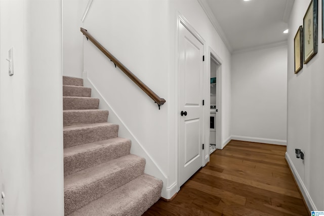 staircase featuring hardwood / wood-style flooring and ornamental molding