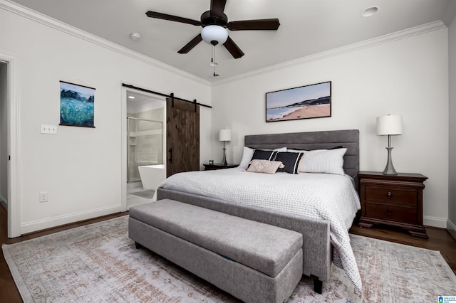 bedroom featuring a barn door, wood-type flooring, crown molding, ceiling fan, and ensuite bath