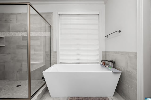 bathroom with plus walk in shower, ornamental molding, and tile walls