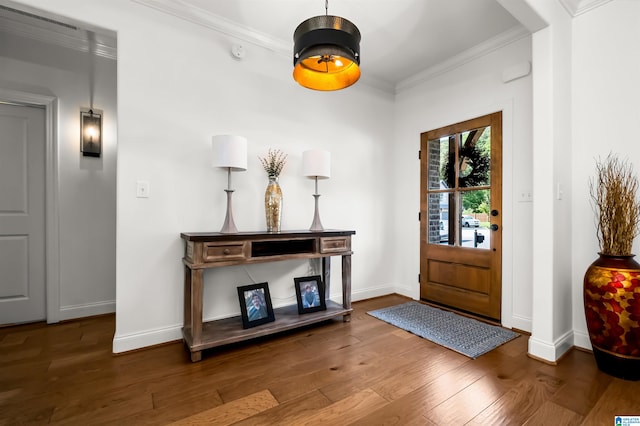 entrance foyer featuring ornamental molding and dark hardwood / wood-style flooring