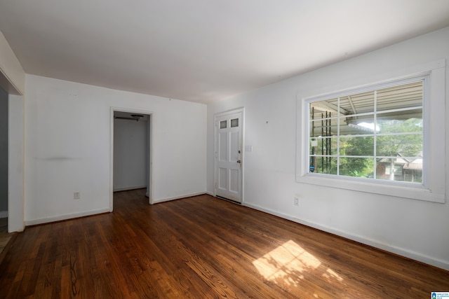 empty room featuring dark wood-type flooring