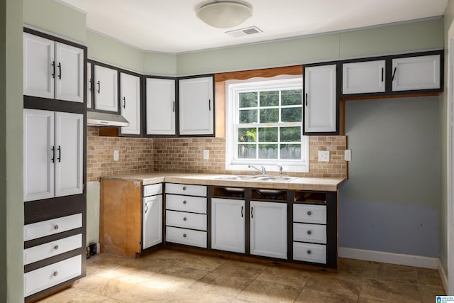 kitchen featuring white cabinets, sink, tasteful backsplash, extractor fan, and tile countertops