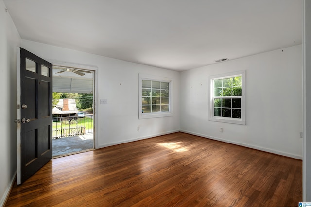 foyer entrance featuring ceiling fan and dark wood-type flooring