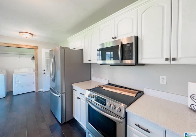 kitchen featuring white cabinets, appliances with stainless steel finishes, dark wood-type flooring, and independent washer and dryer