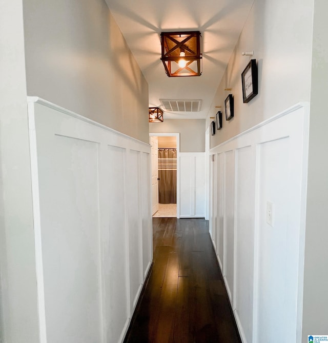 hallway with dark hardwood / wood-style flooring