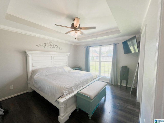 bedroom featuring ornamental molding, ceiling fan, a raised ceiling, and dark hardwood / wood-style flooring