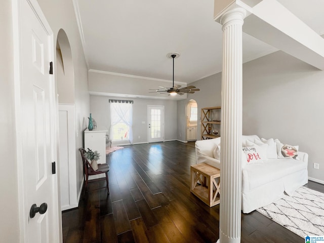 entrance foyer featuring crown molding, decorative columns, dark hardwood / wood-style floors, and ceiling fan