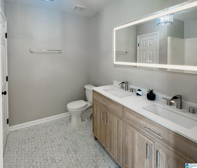 bathroom featuring tile patterned flooring, vanity, and toilet