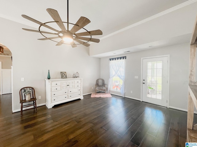 interior space featuring ceiling fan, dark wood-type flooring, and crown molding