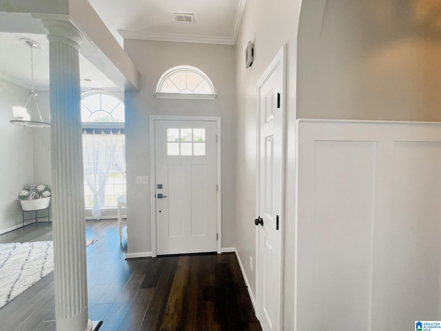 entryway with decorative columns, dark hardwood / wood-style floors, and crown molding