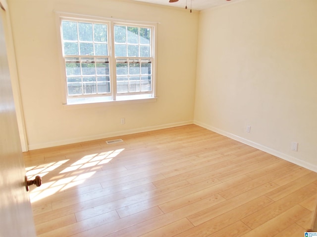 spare room featuring light wood-type flooring and ceiling fan