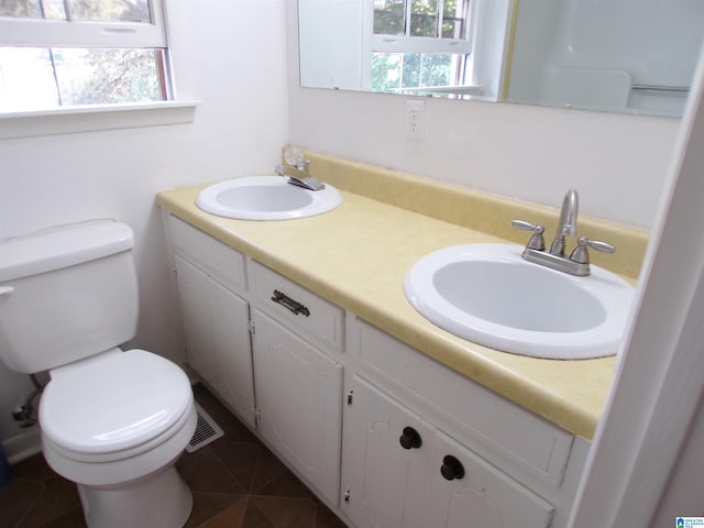 bathroom featuring vanity, toilet, and a wealth of natural light