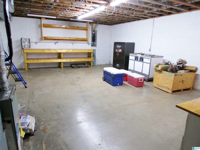 basement featuring a workshop area and electric panel