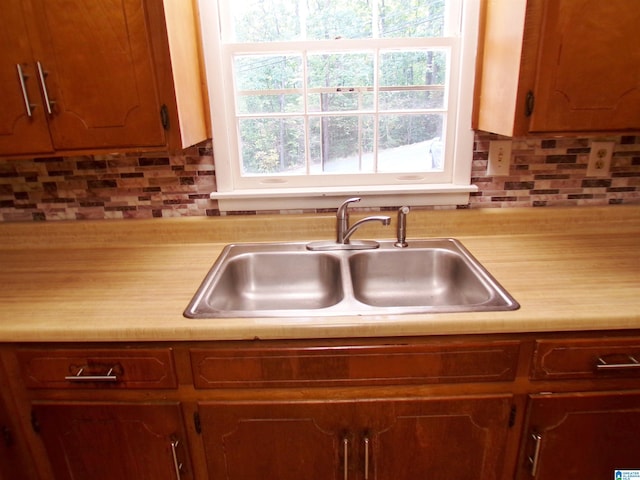 kitchen featuring sink and tasteful backsplash