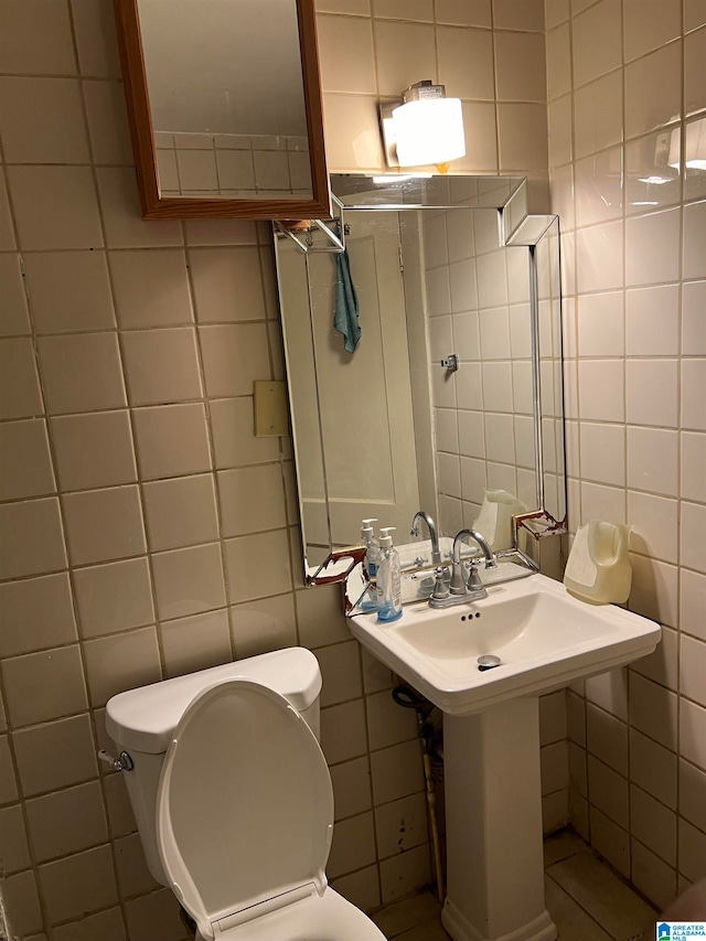 bathroom with tile walls and toilet