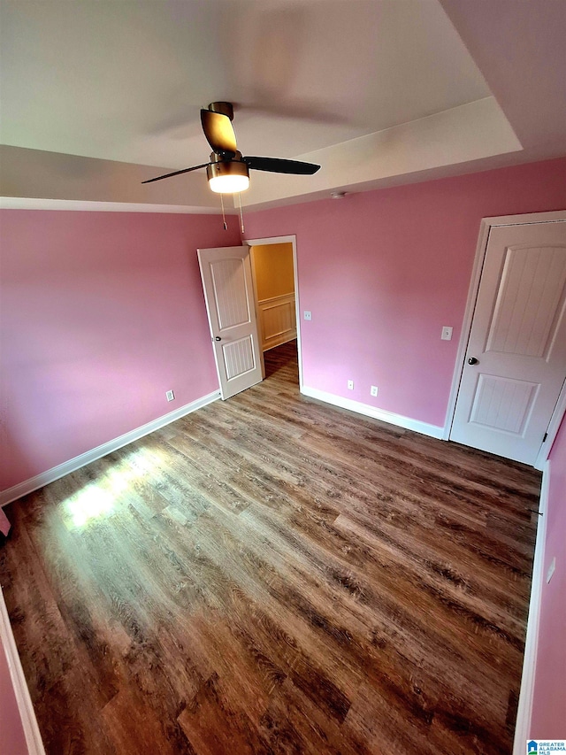 unfurnished bedroom with ceiling fan and hardwood / wood-style floors