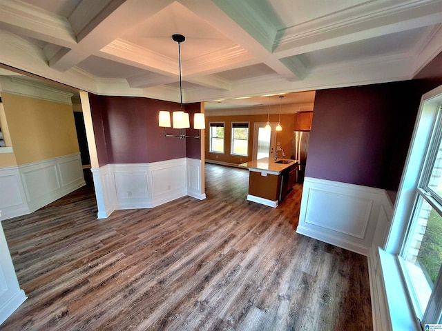 unfurnished dining area featuring ornamental molding, coffered ceiling, beamed ceiling, and dark wood-type flooring