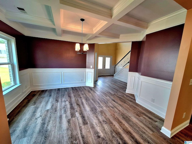 unfurnished dining area featuring a wealth of natural light, wood-type flooring, and beamed ceiling