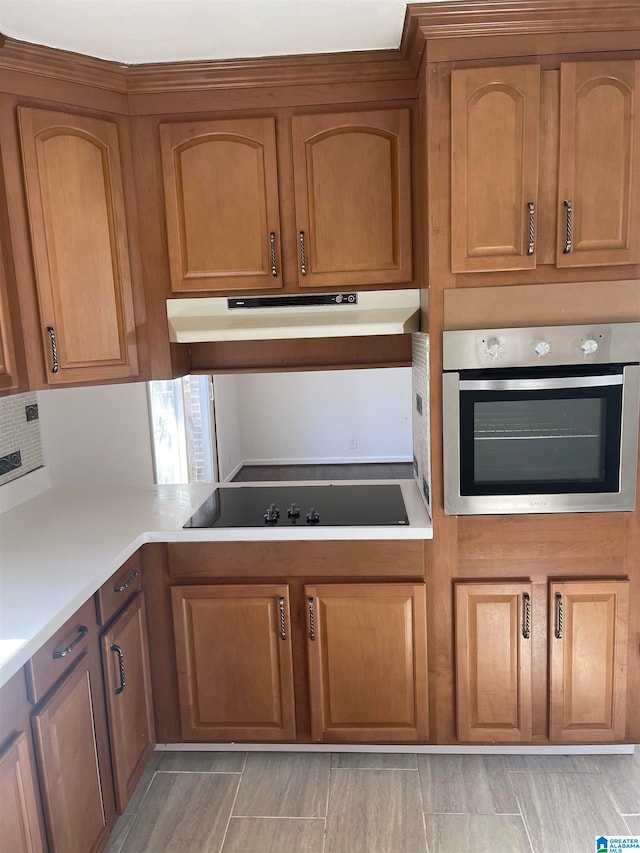 kitchen featuring oven and black electric stovetop