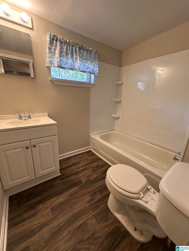 full bathroom featuring wood-type flooring, washtub / shower combination, vanity, and toilet