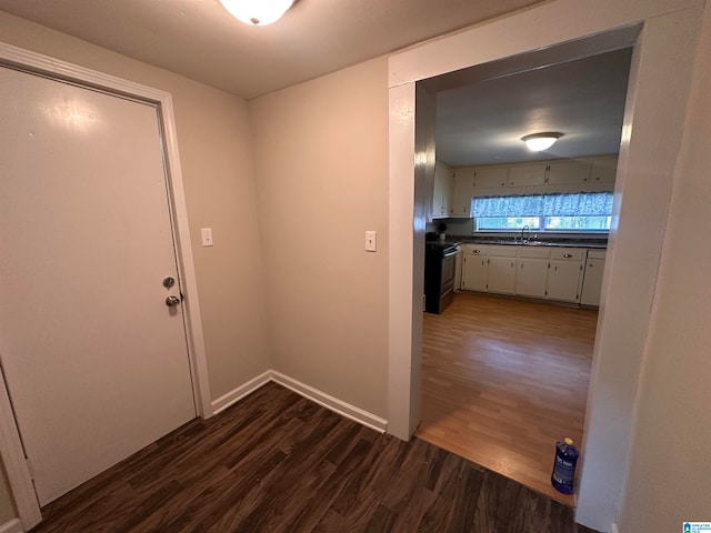 hallway featuring dark hardwood / wood-style flooring and sink