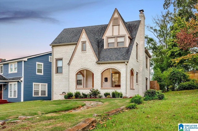 english style home with a yard