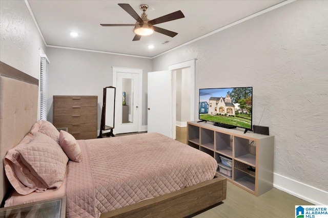 bedroom with ornamental molding and ceiling fan