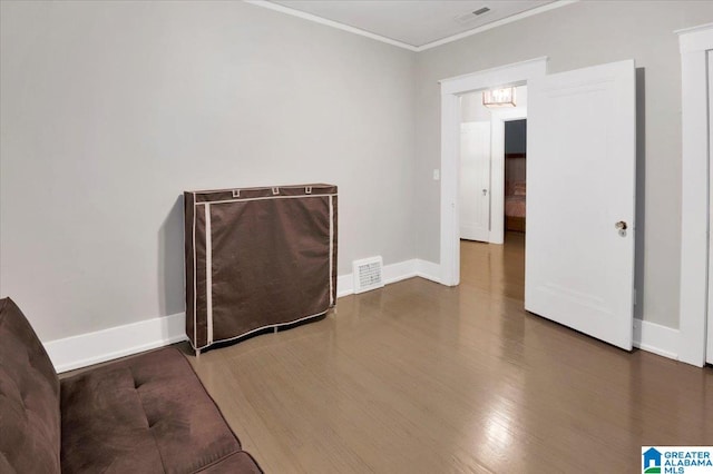 spare room with wood-type flooring and ornamental molding