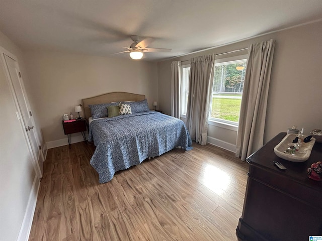 bedroom with wood-type flooring and ceiling fan