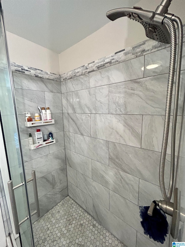 bathroom featuring tile patterned flooring and a shower with shower door