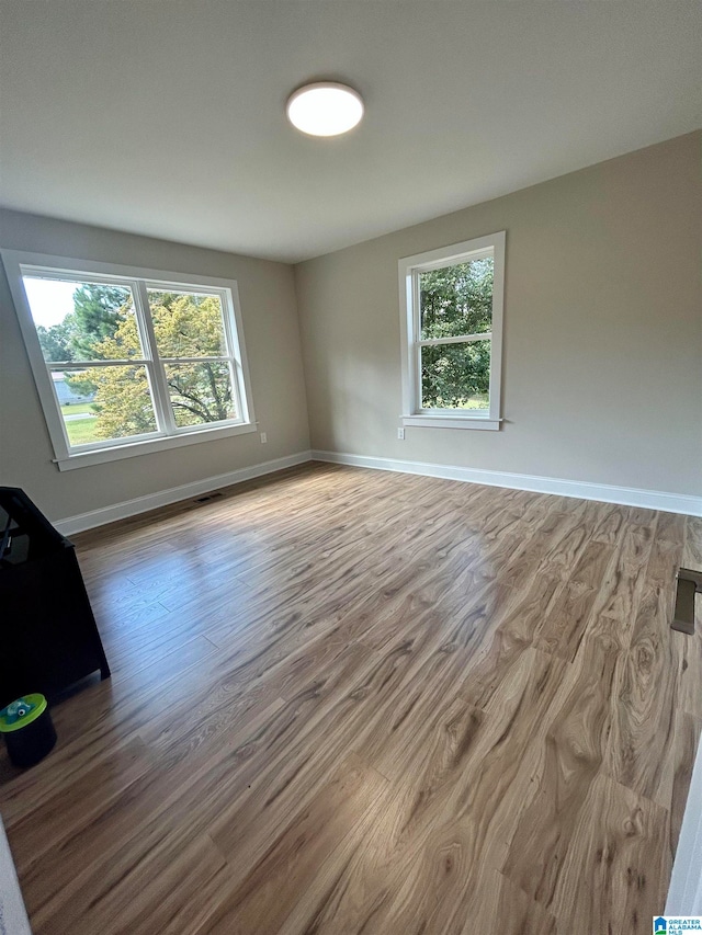 unfurnished room featuring hardwood / wood-style floors