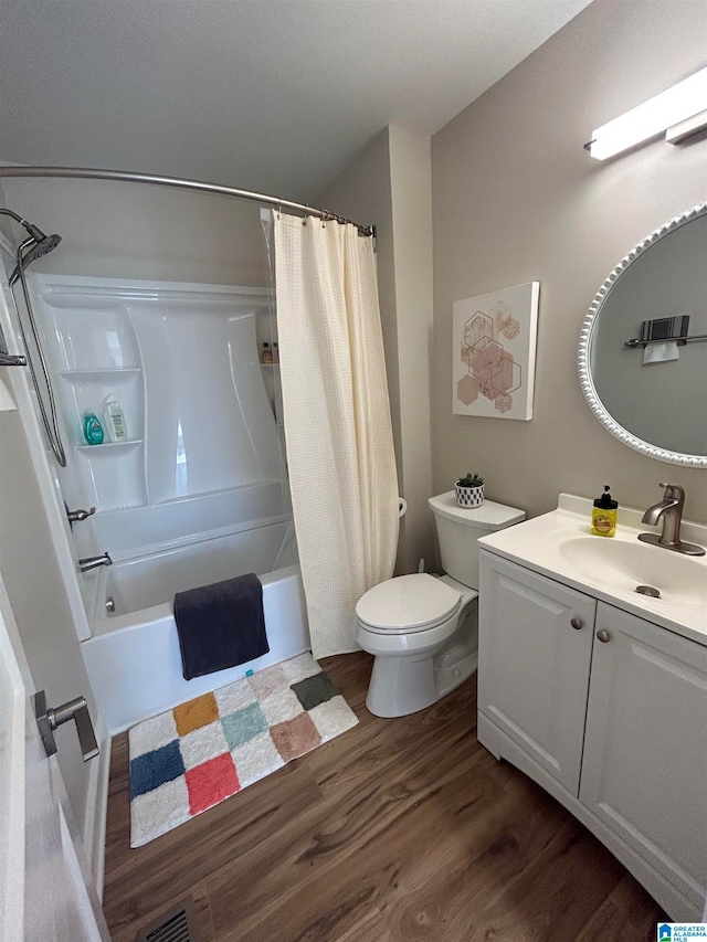 full bathroom with wood-type flooring, shower / bathtub combination with curtain, toilet, and vanity