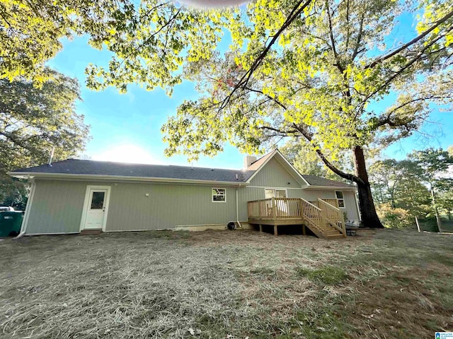 rear view of property featuring a deck