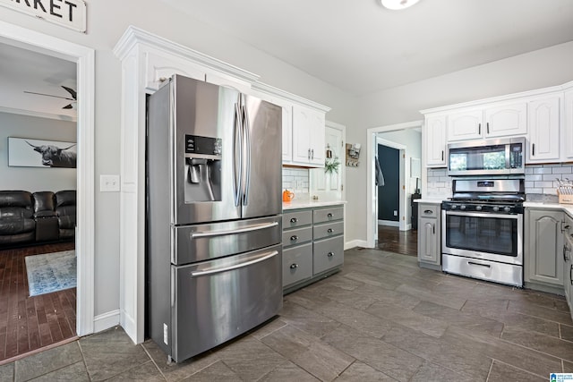 kitchen featuring stainless steel appliances, dark hardwood / wood-style floors, and white cabinetry