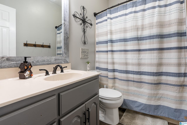 bathroom with toilet, vanity, and a shower with curtain