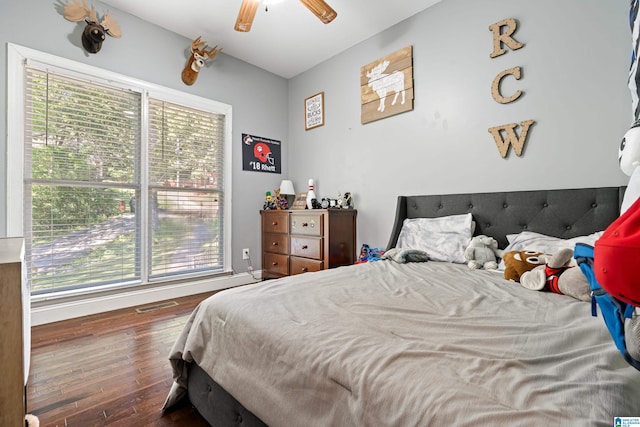 bedroom with ceiling fan and dark wood-type flooring