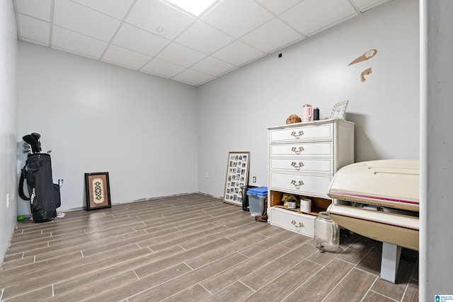 miscellaneous room featuring light wood-type flooring and a paneled ceiling