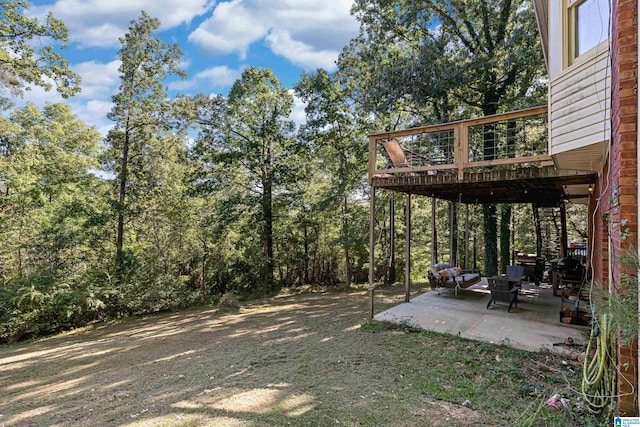 view of yard featuring a patio and a deck