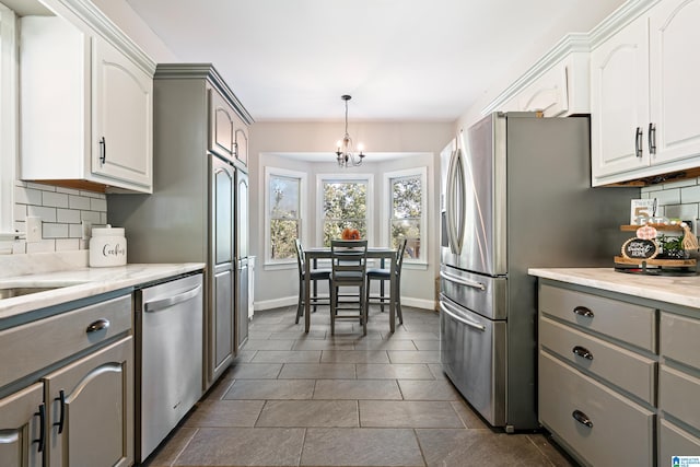 kitchen with backsplash, gray cabinets, stainless steel dishwasher, and white cabinetry