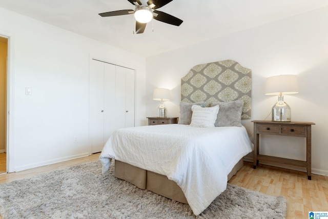 bedroom with light hardwood / wood-style flooring, a closet, and ceiling fan