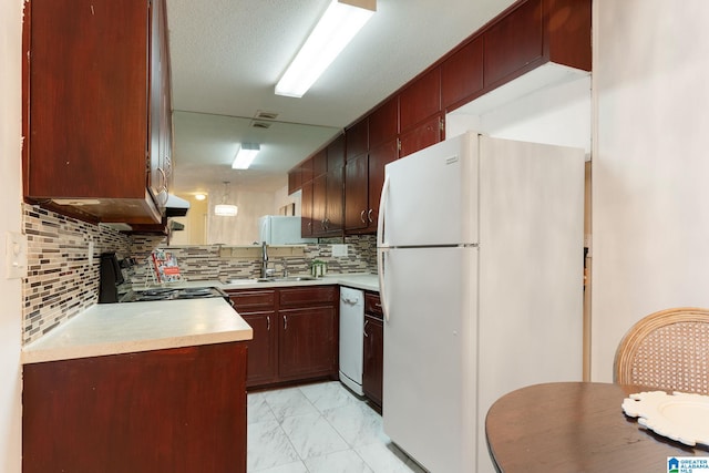 kitchen with backsplash, white appliances, a textured ceiling, and sink