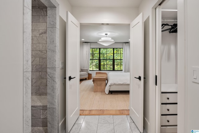 hallway with light hardwood / wood-style floors