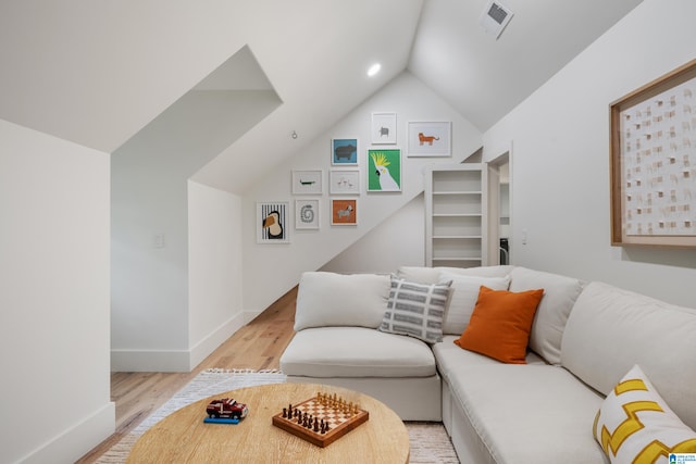 living room with light hardwood / wood-style flooring and lofted ceiling