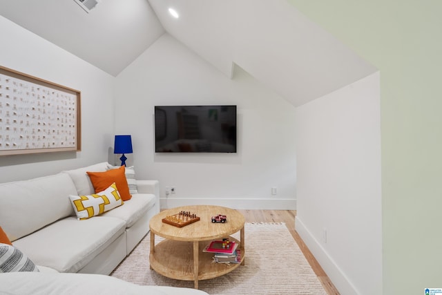 living room featuring light wood-type flooring and lofted ceiling