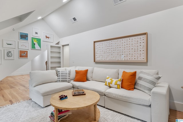 living room with light hardwood / wood-style flooring and lofted ceiling