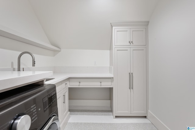 laundry room with washer / clothes dryer, cabinets, and light tile patterned floors