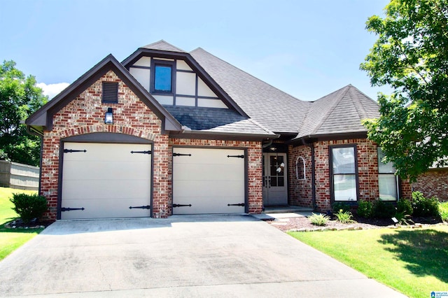 view of front of property featuring a front yard and a garage