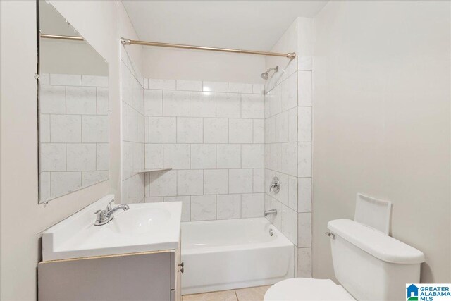 full bathroom with tile patterned floors, toilet, vanity, and tiled shower / bath